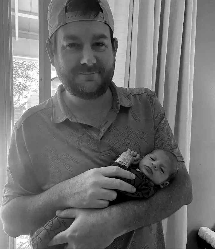 David Turner holding his baby